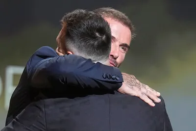 Inter Miami team co-owner and former soccer star David Beckham, right, hugs with Inter Miami's and Argentina's national team player Lionel Messi awarded by the 2023 Ballon d'Or trophy from during the 67th Ballon d'Or (Golden Ball) award ceremony at Theatre du Chatelet in Paris, France, Monday, Oct. 30, 2023. (AP Photo/Michel Euler)