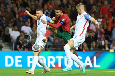 Portugal's Cristiano Ronaldo attempts a shot at goal between Slovakia's Milan Skriniar, left, and Denis Vavro during the Euro 2024 group J qualifying soccer match between Portugal and Slovakia at the Dragao stadium in Porto, Portugal, Friday, Oct. 13, 2023. (AP Photo/Luis Vieira)

- XEURO2024X