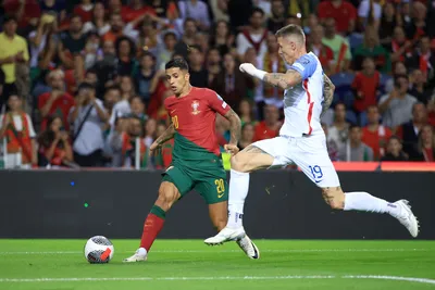 Slovakia's Juraj Kucka tries to block a shot from Portugal's Joao Cancelo, left, during the Euro 2024 group J qualifying soccer match between Portugal and Slovakia at the Dragao stadium in Porto, Portugal, Friday, Oct. 13, 2023. (AP Photo/Luis Vieira)

- XEURO2024X