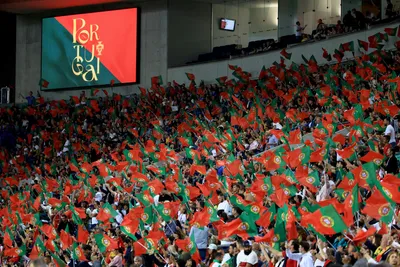 Fans wave Portuguese flags during the Euro 2024 group J qualifying soccer match between Portugal and Slovakia at the Dragao stadium in Porto, Portugal, Friday, Oct. 13, 2023. (AP Photo/Luis Vieira)

- XEURO2024X