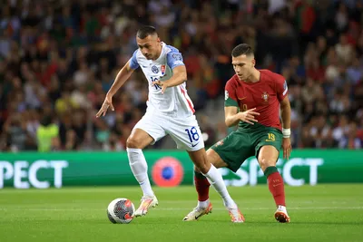 Portugal's Diogo Dalot vies for the ball with Slovakia's Ivan Schranz, left, during the Euro 2024 group J qualifying soccer match between Portugal and Slovakia at the Dragao stadium in Porto, Portugal, Friday, Oct. 13, 2023. (AP Photo/Luis Vieira)

- XEURO2024X