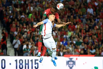 Portugal's Rafael Leao heads the ball above Slovakia's Peter Pekarik during the Euro 2024 group J qualifying soccer match between Portugal and Slovakia at the Dragao stadium in Porto, Portugal, Friday, Oct. 13, 2023. (AP Photo/Luis Vieira)

- XEURO2024X