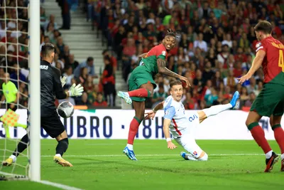 Slovakia goalkeeper Martin Dubravka stops a header from Portugal's Rafael Leao, center, during the Euro 2024 group J qualifying soccer match between Portugal and Slovakia at the Dragao stadium in Porto, Portugal, Friday, Oct. 13, 2023. (AP Photo/Luis Vieira)

- XEURO2024X