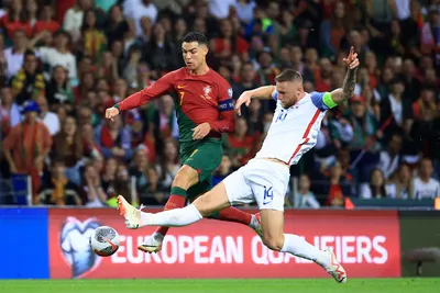 Portugal's Cristiano Ronaldo vies for the ball with Slovakia's Milan Skriniar, right, during the Euro 2024 group J qualifying soccer match between Portugal and Slovakia at the Dragao stadium in Porto, Portugal, Friday, Oct. 13, 2023. (AP Photo/Luis Vieira)

- XEURO2024X