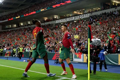 Portugal's Cristiano Ronaldo celebrates with Rafael Leao, left, after scoring his side's second goal from the penalty spot during the Euro 2024 group J qualifying soccer match between Portugal and Slovakia at the Dragao stadium in Porto, Portugal, Friday, Oct. 13, 2023. (AP Photo/Luis Vieira)

- XEURO2024X