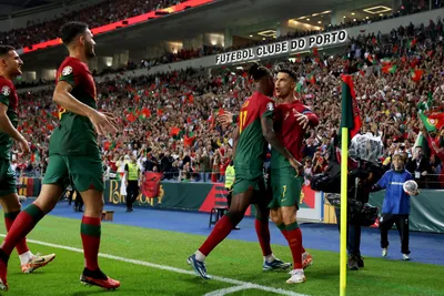 Portugal's Cristiano Ronaldo, right, celebrates after scoring his side's second goal from the penalty spot during the Euro 2024 group J qualifying soccer match between Portugal and Slovakia at the Dragao stadium in Porto, Portugal, Friday, Oct. 13, 2023. (AP Photo/Luis Vieira)

- XEURO2024X