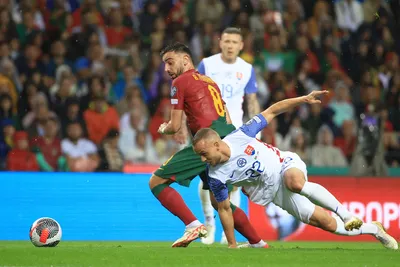 Portugal's Bruno Fernandes, left, drives the ball past Slovakia's Stanislav Lobotka during the Euro 2024 group J qualifying soccer match between Portugal and Slovakia at the Dragao stadium in Porto, Portugal, Friday, Oct. 13, 2023. (AP Photo/Luis Vieira)

- XEURO2024X