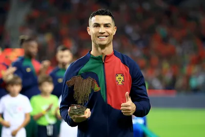 Portugal's Cristiano Ronaldo poses with his award for 200 caps before the Euro 2024 group J qualifying soccer match between Portugal and Slovakia at the Dragao stadium in Porto, Portugal, Friday, Oct. 13, 2023. (AP Photo/Luis Vieira)

- XEURO2024X