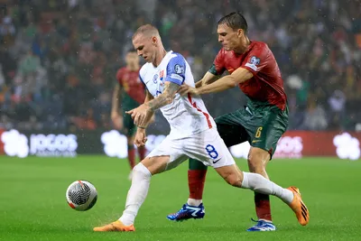 Portugal's Joao Palhinha vies for the ball with Slovakia's Ondrej Duda, left, during the Euro 2024 group J qualifying soccer match between Portugal and Slovakia at the Dragao stadium in Porto, Portugal, Friday, Oct. 13, 2023. (AP Photo/Luis Vieira)

- XEURO2024X