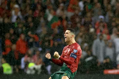 Portugal's Cristiano Ronaldo celebrates after scoring his side's third goal during the Euro 2024 group J qualifying soccer match between Portugal and Slovakia at the Dragao stadium in Porto, Portugal, Friday, Oct. 13, 2023. (AP Photo/Luis Vieira)

- XEURO2024X