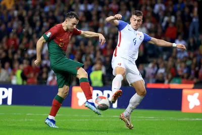 Portugal's Diogo Jota attempts a shot at goal past Slovakia's Michal Tomic, right, during the Euro 2024 group J qualifying soccer match between Portugal and Slovakia at the Dragao stadium in Porto, Portugal, Friday, Oct. 13, 2023. (AP Photo/Luis Vieira)

- XEURO2024X