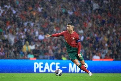 Portugal's Cristiano Ronaldo runs with the ball during the Euro 2024 group J qualifying soccer match between Portugal and Slovakia at the Dragao stadium in Porto, Portugal, Friday, Oct. 13, 2023. (AP Photo/Luis Vieira)

- XEURO2024X