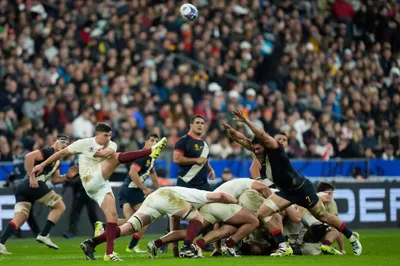 England's Owen Farrell, left, kicks the ball during the Rugby World Cup third place match between England and Argentina at the Stade de France in Saint-Denis, outside Paris, Friday, Oct. 27, 2023. (AP Photo/Pavel Golovkin)