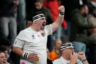 An England fan celebrates during the Rugby World Cup third place match between England and Argentina at the Stade de France in Saint-Denis, outside Paris, Friday, Oct. 27, 2023. (AP Photo/Themba Hadebe)