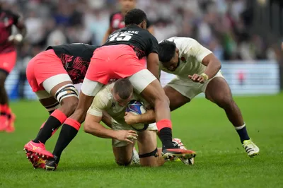 England's Ben Earl, center, is tacked during the Rugby World Cup quarterfinal match between England and Fiji at the Stade de Marseille in Marseille, France, Sunday, Oct. 15, 2023. (AP Photo/Pavel Golovkin)