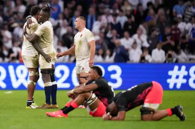 England's players celebrate at the end of the Rugby World Cup quarterfinal match between England and Fiji at the Stade de Marseille in Marseille, France, Sunday, Oct. 15, 2023. (AP Photo/Pavel Golovkin)