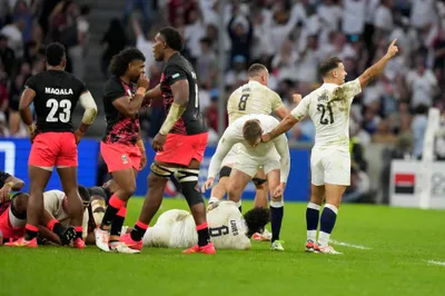 England's players celebrate at the end of the Rugby World Cup quarterfinal match between England and Fiji at the Stade de Marseille in Marseille, France, Sunday, Oct. 15, 2023. (AP Photo/Pavel Golovkin)