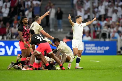 England's players celebrate at the end of the Rugby World Cup quarterfinal match between England and Fiji at the Stade de Marseille in Marseille, France, Sunday, Oct. 15, 2023. (AP Photo/Pavel Golovkin)