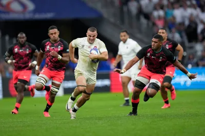 England's Ben Earl, center, runs with the ball during the Rugby World Cup quarterfinal match between England and Fiji at the Stade de Marseille in Marseille, France, Sunday, Oct. 15, 2023. (AP Photo/Pavel Golovkin)