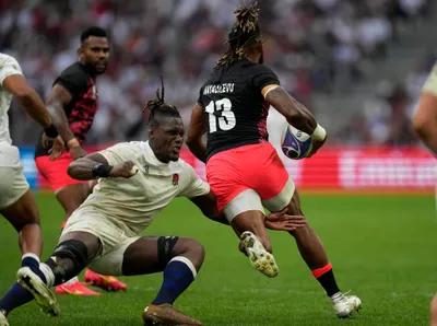 England's Maro Itoje, left, tables Fiji's Waisea Nayacalevu during the Rugby World Cup quarterfinal match between England and Fiji at the Stade de Marseille in Marseille, France, Sunday, Oct. 15, 2023. (AP Photo/Pavel Golovkin)