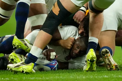 England's Maro Itoje pass the ball back in a ruck during the Rugby World Cup semifinal match between England and South Africa at the Stade de France in Saint-Denis, outside Paris, Saturday, Oct, 21, 2023. (AP Photo/Christophe Ena)