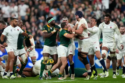 England's George Martin, center right, challenges South Africa's Cobus Reinach, center left, during the Rugby World Cup semifinal match between England and South Africa at the Stade de France in Saint-Denis, outside Paris, Saturday, Oct. 21, 2023. (AP Photo/Pavel Golovkin)