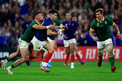 France's Matthieu Jalibert, right, challenges for the ball with South Africa's Jesse Kriel during the Rugby World Cup quarterfinal match between France and South Africa at the Stade de France in Saint-Denis, near Paris, Sunday, Oct. 15, 2023. (AP Photo/Aurelien Morissard)