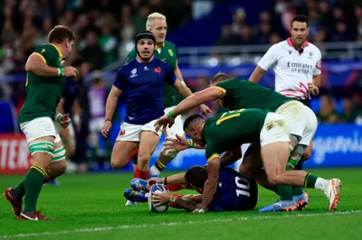 France's Matthieu Jalibert, bottom, defends the ball during the Rugby World Cup quarterfinal match between France and South Africa at the Stade de France in Saint-Denis, near Paris, Sunday, Oct. 15, 2023. (AP Photo/Aurelien Morissard)