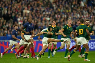 South Africa's Cheslin Kolbe clears the ball during the Rugby World Cup quarterfinal match between France and South Africa at the Stade de France in Saint-Denis, near Paris Sunday, Oct. 15, 2023. (AP Photo/Thibault Camus)