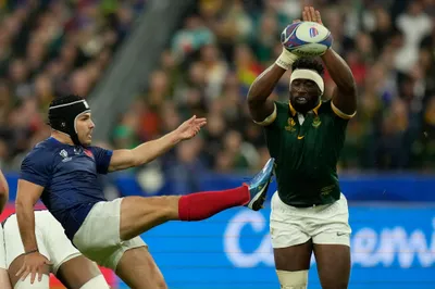 South Africa's Siya Kolisi tries to charge down a kick from France's Antoine Dupont during the Rugby World Cup quarterfinal match between France and South Africa at the Stade de France in Saint-Denis, near Paris Sunday, Oct. 15, 2023. (AP Photo/Thibault Camus)