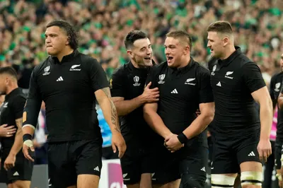 New Zealand players celebrate after the end of the Rugby World Cup quarterfinal match between Ireland and New Zealand at the Stade de France in Saint-Denis, near Paris Saturday, Oct. 14, 2023. New Zealand won the game 28-24. (AP Photo/Christophe Ena)