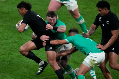 New Zealand's Rieko Ioane, left, is tackled by Ireland's Andrew Porter during the Rugby World Cup quarterfinal match between Ireland and New Zealand at the Stade de France in Saint-Denis, near Paris Saturday, Oct. 14, 2023. (AP Photo/Themba Hadebe)