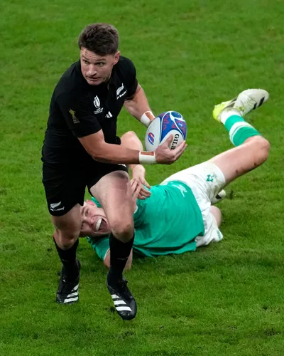 New Zealand's Beauden Barrett, front, breaks away from Ireland's Garry Ringrose during the Rugby World Cup quarterfinal match between Ireland and New Zealand at the Stade de France in Saint-Denis, near Paris Saturday, Oct. 14, 2023. (AP Photo/Themba Hadebe)