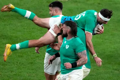 Ireland's Hugo Keenan, top, is catched by teammates after jumping for the ball during the Rugby World Cup quarterfinal match between Ireland and New Zealand at the Stade de France in Saint-Denis, near Paris, Saturday, Oct. 14, 2023. (AP Photo/Themba Hadebe)