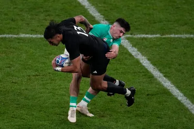 New Zealand's Rieko Ioane, left, is tackled by Ireland's Jimmy O'Brien during the Rugby World Cup quarterfinal match between Ireland and New Zealand at the Stade de France in Saint-Denis, near Paris Saturday, Oct. 14, 2023. (AP Photo/Themba Hadebe)