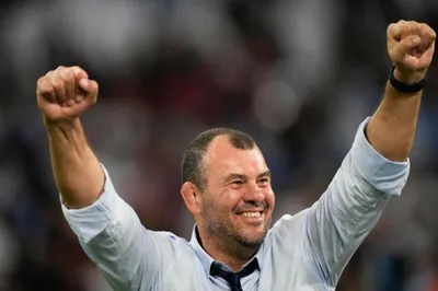 Argentina's head coach Michael Cheika celebrates at the end of the Rugby World Cup quarterfinal match between Wales and Argentina at the Stade de Marseille in Marseille, France, Saturday, Oct. 14, 2023. (AP Photo/Pavel Golovkin)