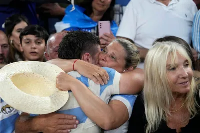 Argentina's Mateo Carreras hugs relatives and friends at the end of the Rugby World Cup quarterfinal match between Wales and Argentina at the Stade de Marseille in Marseille, France, Saturday, Oct. 14, 2023. (AP Photo/Pavel Golovkin)