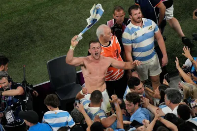 Argentina's Emiliano Boffelli sings with fans after the Rugby World Cup quarterfinal match between Wales and Argentina at the Stade de Marseille in Marseille, France, Saturday, Oct. 14, 2023. (AP Photo/Daniel Cole)