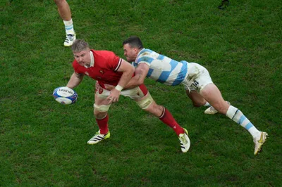 Wales' Aaron Wainwright is tackled by Argentina's Emiliano Boffelli during the Rugby World Cup quarterfinal match between Wales and Argentina at the Stade de Marseille in Marseille, France, Saturday, Oct. 14, 2023. (AP Photo/Daniel Cole)