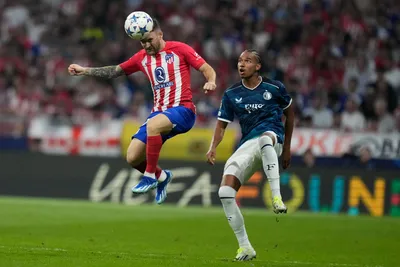 Atletico Madrid's Javi Galan, left, heads the ball as Feyenoord's Calvin Stengs looks on during the Champions League Group E soccer match between Atletico Madrid and Feyenoord at the Metropolitano stadium in Madrid, Spain, Wednesday, Oct. 4, 2023. (AP Photo/Bernat Armangue)

- XCHAMPIONSLEAGUEX