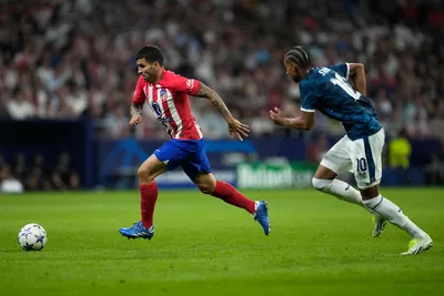 Atletico Madrid's Angel Correa, left, controls the ball as Feyenoord's Calvin Stengs runs to stop him during the Champions League Group E soccer match between Atletico Madrid and Feyenoord at the Metropolitano stadium in Madrid, Spain, Wednesday, Oct. 4, 2023. (AP Photo/Bernat Armangue)

- XCHAMPIONSLEAGUEX