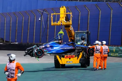 The Williams car of Alexander Albon of Thailand is lifted from the track after he crashed during the Brazilian Formula One Grand Prix at the Interlagos race track in Sao Paulo, Brazil, Sunday, Nov. 5, 2023. (AP Photo/Andre Penner)