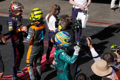 Aston Martin driver Fernando Alonso of Spain, right, celebrates finishing third in the Brazilian Formula One Grand Prix at the Interlagos race track in Sao Paulo, Brazil, Sunday, Nov. 5, 2023. (AP Photo/Andre Penner)