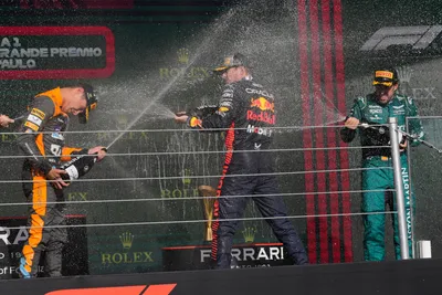 Winner Red Bull driver Max Verstappen of the Netherlands, center, sprays champagne on the podium with second place McLaren driver Lando Norris of Britain, left, and third place Aston Martin driver Fernando Alonso of Spain at the end of the Brazilian Formula One Grand Prix at the Interlagos race track in Sao Paulo, Brazil, Sunday, Nov. 5, 2023. (AP Photo/Andre Penner)