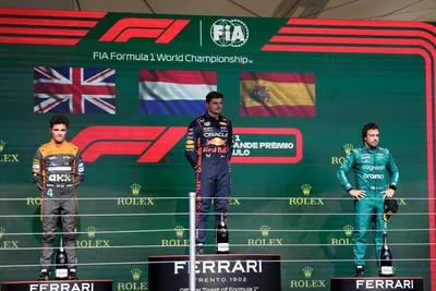 Winner Red Bull driver Max Verstappen of the Netherlands, center, second place McLaren driver Lando Norris of Britain, left, and third place Aston Martin driver Fernando Alonso of Spain stand on the podium at the end of the Brazilian Formula One Grand Prix at the Interlagos race track in Sao Paulo, Brazil, Sunday, Nov. 5, 2023. (AP Photo/Andre Penner)