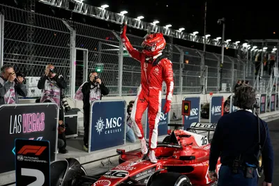 Ferrari driver Charles Leclerc, of Monaco, celebrates on top of his car after a second place finish during the Formula One Las Vegas Grand Prix auto race, Saturday, Nov. 18, 2023, in Las Vegas. (AP Photo/John Locher)