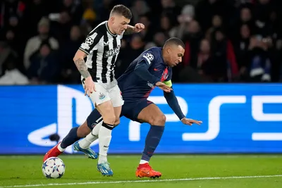 Newcastle's Kieran Trippier vies for the ball with PSG's Kylian Mbappe, right, during the Champions League group F soccer match between Paris Saint-Germain and Newcastle United FC at the Parc des Princes in Paris, Tuesday, Nov. 28, 2023. (AP Photo/Christophe Ena)

- XCHAMPIONSLEAGUEX