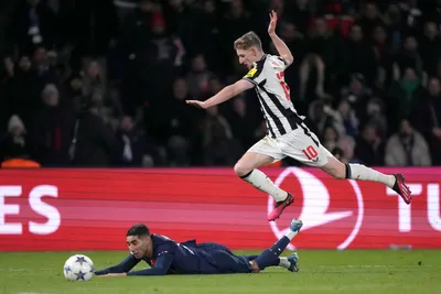 PSG's Achraf Hakimi, bottom, challenges for the ball with Newcastle's Anthony Gordon during the Champions League group F soccer match between Paris Saint-Germain and Newcastle United FC at the Parc des Princes in Paris, Tuesday, Nov. 28, 2023. (AP Photo/Thibault Camus)

- XCHAMPIONSLEAGUEX