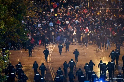 Security forces clash with Bulgarian fans outside the empty Vasil Levski National Stadium prior to the UEFA Euro 2024 Group G qualifying soccer match between Bulgaria and Hungary in Sofia, Bulgaria, Thursday, Nov. 16, 2023. (Zsolt Szigetvary/MTI via AP)