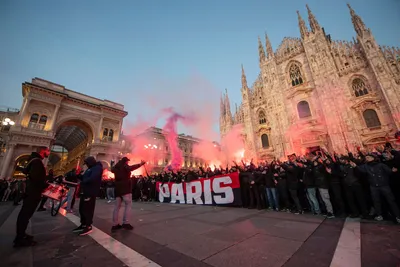 PSG fans light flares in front of Milan's gothic cathedral, Italy, ahead of the Champions League soccer match between AC Milan and Paris-Saint Germain, in Milan, Italy, Tuesday, Nov. 7, 2023. (Claudio Furlan/LaPresse via AP)